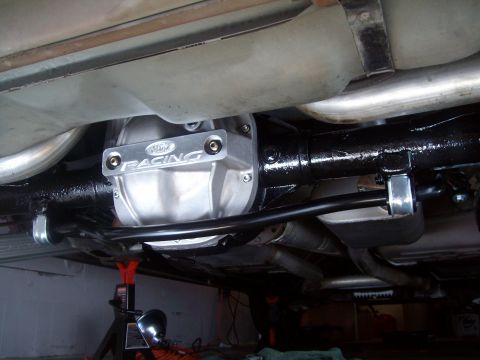 2004 Ford Crown Victoria - The underside of a Ford Crown Victoria shows a Ford Racing differential cover and exhaust system, supported by jack stands.