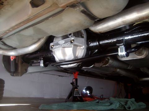 2004 Ford Crown Victoria - The underside of a Ford Crown Victoria shows a rear differential cover with "Ford Racing" branding, a black painted rear axle, and exhaust…