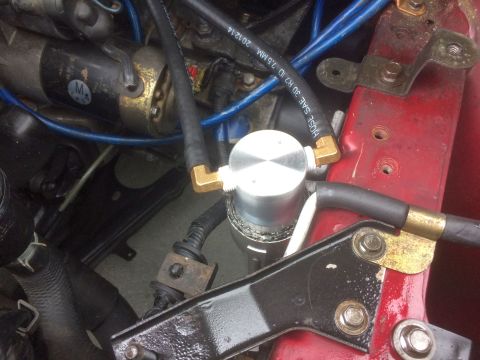 1993 Mazda MX-3 - Close-up view of various engine components and wiring within a vehicle's engine bay.