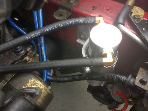 1993 Mazda MX-3 - Hoses and engine components are visible in this close-up engine bay shot.