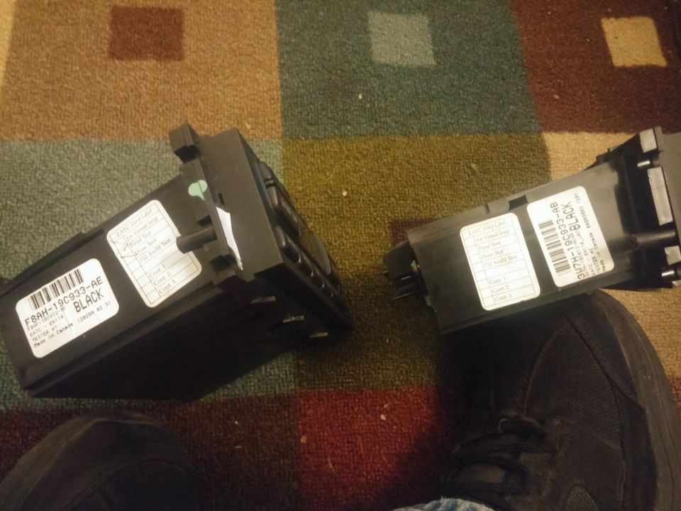 Two black electronic modules with barcode part-number labels