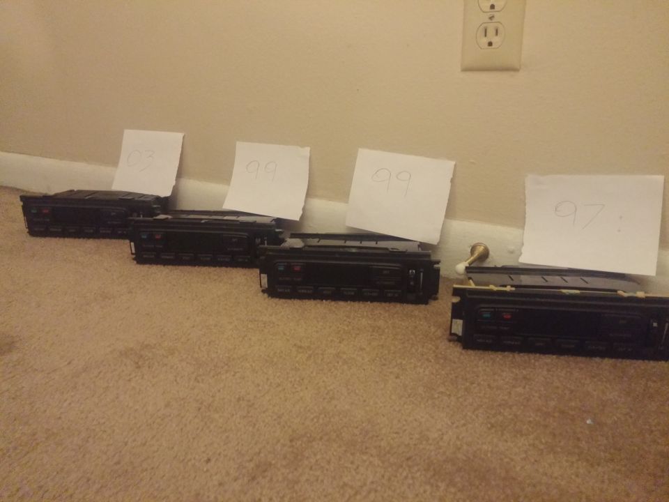 Row of four climate control modules with year notes on a floor