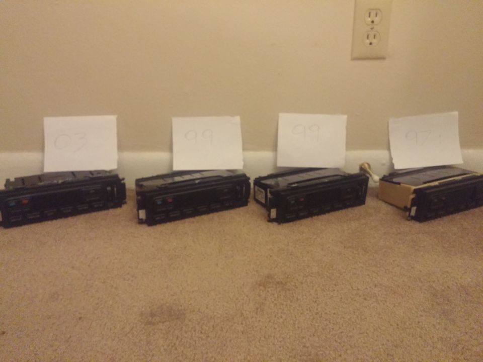 Row of four climate control modules with year notes on a floor