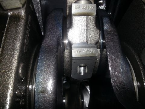 1994 Ford Bronco - A close-up view of a crankshaft with the part number "VF 49927" stamped on it. The crankshaft appears to be part of an engine assembly.