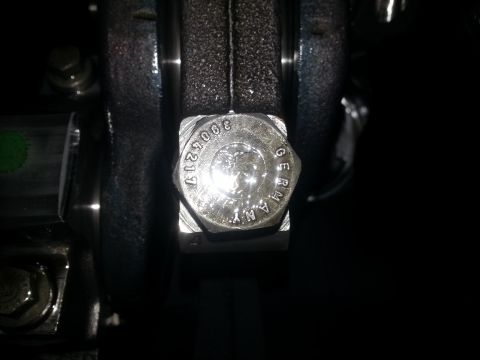 1994 Ford Bronco - A close-up of a bolt with the text "3005217 GERMANY" stamped on its head. The bolt appears to be part of an engine or mechanical assembly.