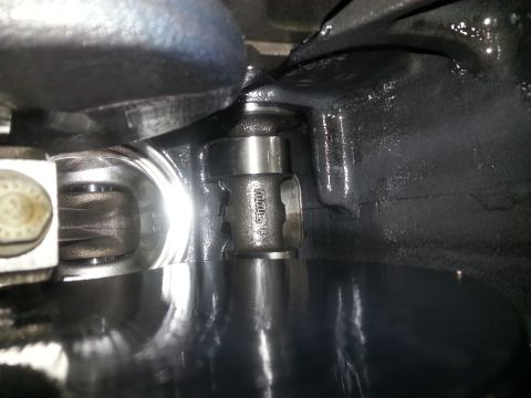 1994 Ford Bronco - A close-up view of internal engine components, likely a crankshaft and connecting rod assembly, with visible oil.