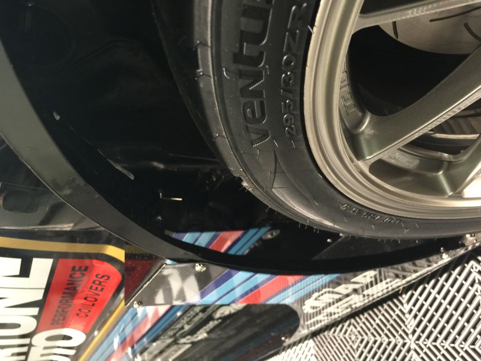 Underside of a vehicle showing a tire with text "VENTUS 295/30ZR20" and wheel.