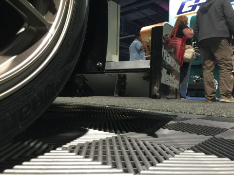 1993 Mercury Tracer - Low angle view of a car's wheel and fender at a trade show event.