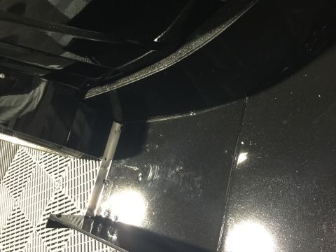 1993 Mercury Tracer - Close-up view of the undercarriage of a vehicle, revealing structural components and black painted surfaces.