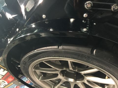 1993 Mercury Tracer - Close-up of a black widebody fender flare and wheel, the SuperMotors logo at the bottom.