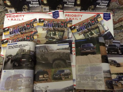 1987 Ford Bronco - A collection of Ford Bronco memorabilia, including magazines and Priority Mail packages.