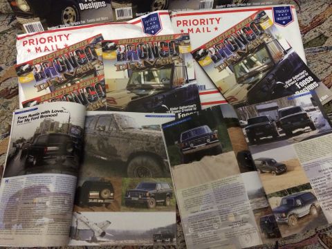 1987 Ford Bronco - Multiple publications and mailers Ford Broncos are spread out on a surface.