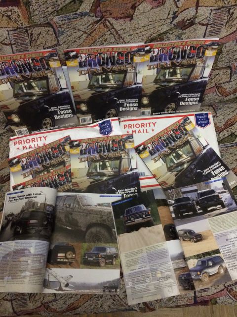 1987 Ford Bronco - Multiple publications Ford Broncos are stacked and scattered across a patterned surface.