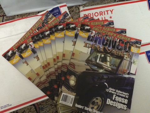 1987 Ford Bronco - Multiple issues of Bronco Driver Collector's Series magazines are fanned out on a patterned surface.