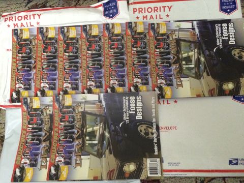 1987 Ford Bronco - A collection of automotive magazines, including 'Bronco Collector's Series' and 'Foose Designs', are arranged with Priority Mail envelopes.