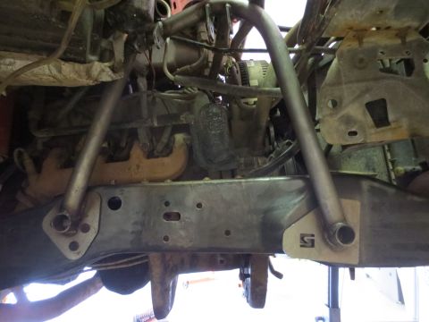 1996 Ford Bronco - Underside view of engine and chassis components, a custom bracket with an 'S' logo.