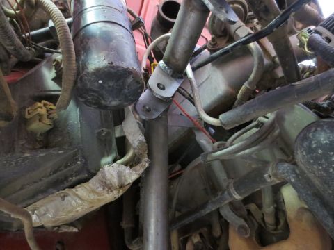 1996 Ford Bronco - Close-up of an engine bay with various components and a newly fabricated bracket.