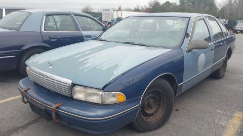 1991 Ford LTD Crown Victoria - A two-tone Chevrolet Caprice sits in a parking lot next to another similar vehicle.