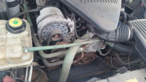 1991 Ford LTD Crown Victoria - Close-up view of a V8 engine bay, showing the alternator and coolant reservoir.