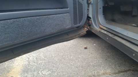 1991 Ford LTD Crown Victoria - Photograph of a vehicle door sill and rocker panel, not a technical document.