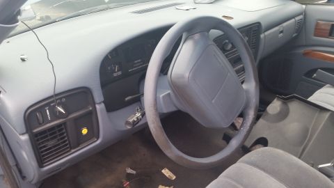 1991 Ford LTD Crown Victoria - Photograph of a sedan interior dashboard and steering wheel, not a technical document.