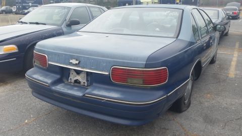1991 Ford LTD Crown Victoria - Photograph of the rear of a blue Chevrolet Caprice sedan, not a technical document.