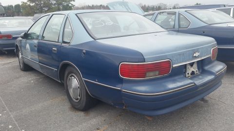 1991 Ford LTD Crown Victoria - Photograph of a blue Chevrolet Caprice sedan from the rear three-quarter, not a technical document.