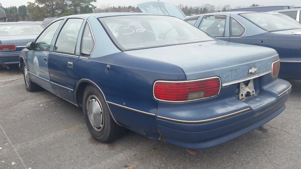 Rear three-quarter view of a blue Chevrolet Caprice sedan