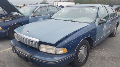 1991 Ford LTD Crown Victoria - Photograph of the front of a two-tone blue Chevrolet Caprice sedan, not a technical document.