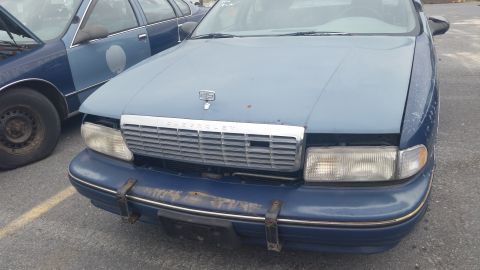 1991 Ford LTD Crown Victoria - Photograph of the front end of a faded blue Chevrolet Caprice, not a technical document.