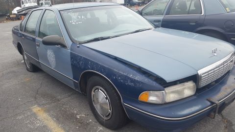 1991 Ford LTD Crown Victoria - Photograph of a weathered blue Chevrolet Caprice sedan, not a technical document.