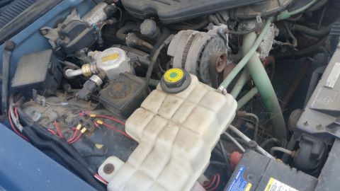 1991 Ford LTD Crown Victoria - Photograph of a Caprice engine bay with coolant tank and brake master cylinder, not a document.