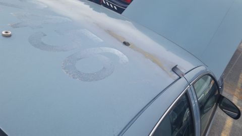 1991 Ford LTD Crown Victoria - Photograph of a Caprice hood and roof with worn paint, not a technical document.