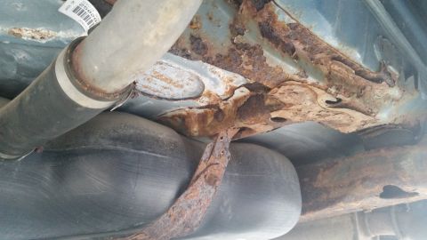 1991 Ford LTD Crown Victoria - Photograph of the rusted underbody and exhaust of a Caprice, not a technical document.