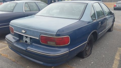 1991 Ford LTD Crown Victoria - Photograph of the rear of a blue Chevrolet Caprice sedan, not a technical document.