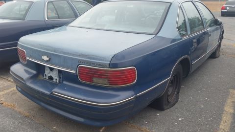 1991 Ford LTD Crown Victoria - Photograph of the rear of a blue Chevrolet Caprice Classic sedan, not a technical document.