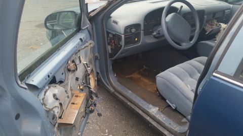 1991 Ford LTD Crown Victoria - Photograph of a vehicle interior with dashboard and exposed door wiring, not a technical document.
