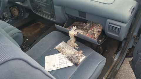 1991 Ford LTD Crown Victoria - Photograph of a vehicle interior with open glovebox and loose papers, not a technical document.