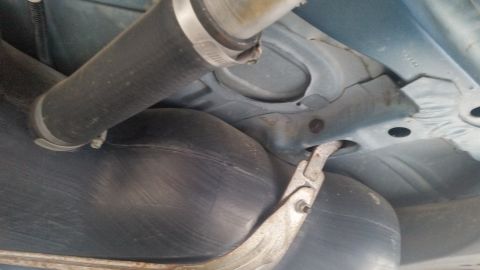 1991 Ford LTD Crown Victoria - Photograph of a vehicle's interior underside floor pan and seat structure, not a document.