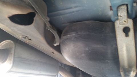 1991 Ford LTD Crown Victoria - Photograph of a vehicle undercarriage showing the fuel tank and muffler, not a document.
