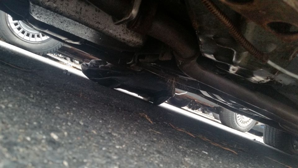 Photo of vehicle undercarriage and rocker with exhaust and wheel