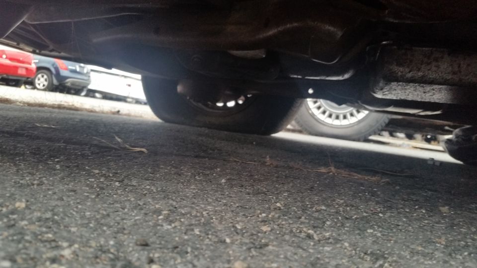 Photo of vehicle rear undercarriage with axle and exhaust