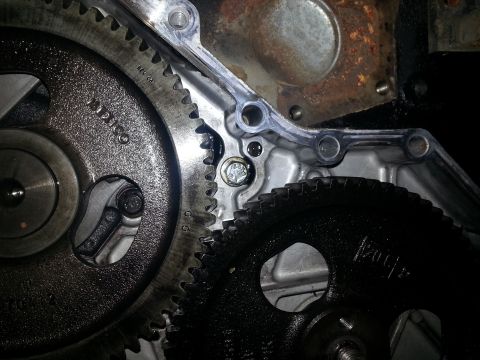 1994 Ford Bronco - A close-up view shows two meshing gears, likely from an engine's timing system. One gear is silver with visible text "MEXICO" and "REV 06",…