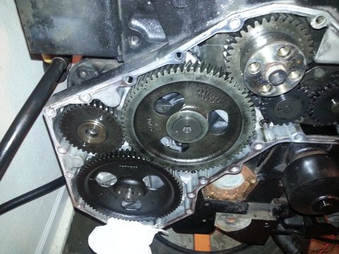 1994 Ford Bronco - A close-up view of the internal gears of a vehicle engine, likely a timing gear set. The gears are black and metallic, with some grease and…