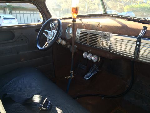 1968 Ford Mustang - Photograph of a patina vintage truck interior showing the steering wheel, dash and gauges.
