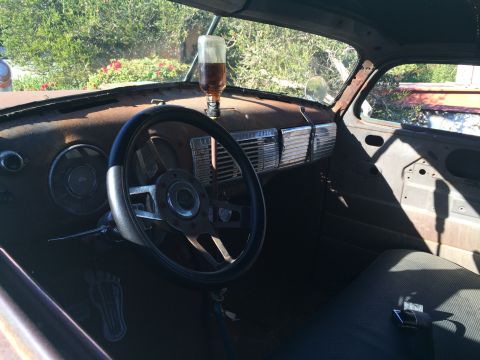 1968 Ford Mustang - Photograph of the patina interior of a vintage car showing the steering wheel and dash.
