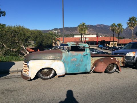 1968 Ford Mustang - Photograph of a lowered patina 1940s-50s Chevrolet pickup truck parked along a curb.