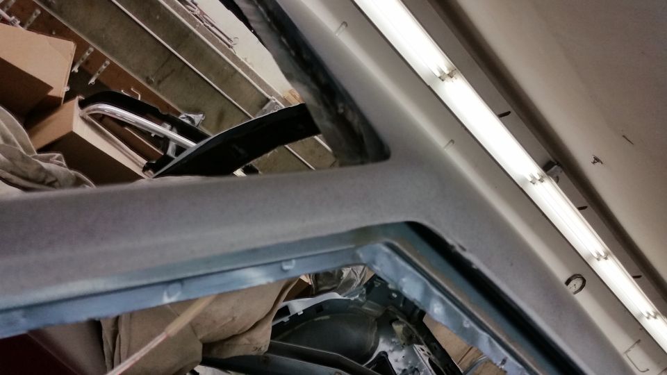 Close-up of a car windshield pillar and interior trim during bodywork