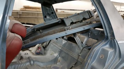 2001 Ford Crown Victoria - Photograph of a gutted car body rear section during restoration, not a technical document.