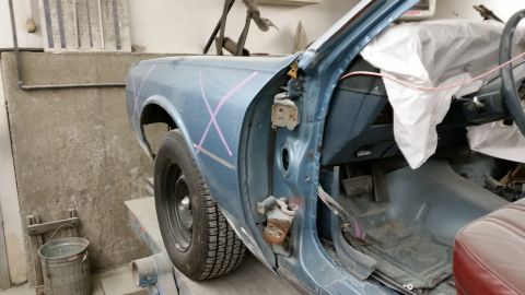 2001 Ford Crown Victoria - Photograph of a car body rear quarter with guide-coat marks during bodywork, not a technical document.